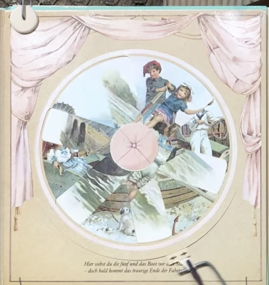 The same book page with the wheel turned partway, showing a different image